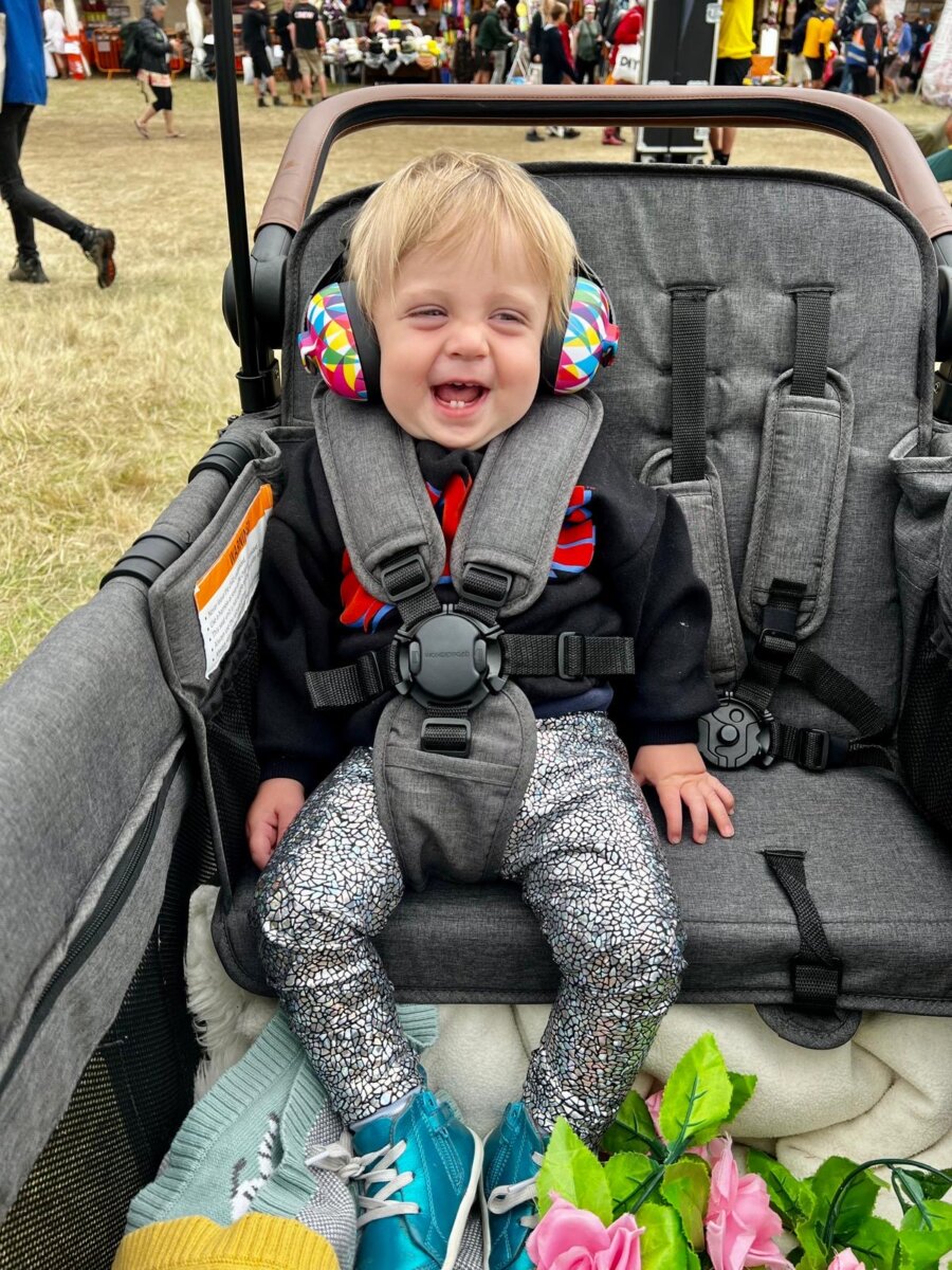 image of baby smiling whilst sat in his wagon