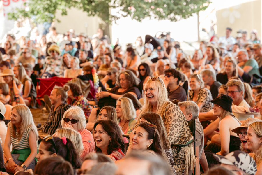 image of people smiling in the comedy arena at latitude