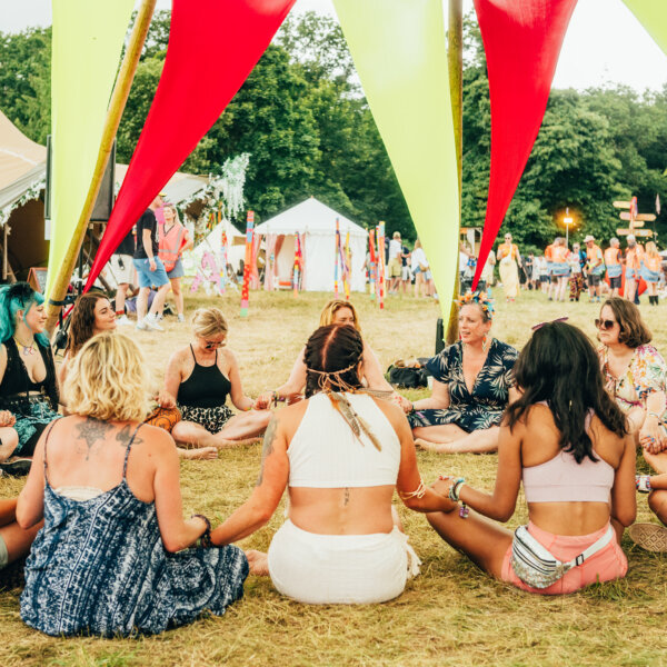 a group sat in a circle holding hands