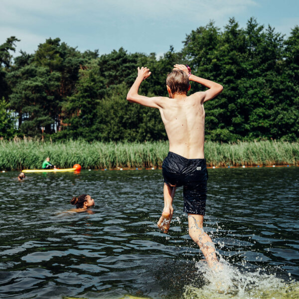 a boy jumping into the water